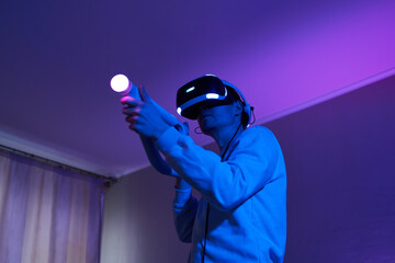 Wall Mural - man with virtual reality headset and joystic is playing game