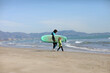 © Andriy Medvediuk - father teaching his child surfing on the beach by the sea. excited girl or boy doing execises developing new skills. Surfing, fatherhood concept