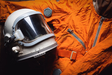 concept of astranaut helmet and space suit on the old table flat lay background.