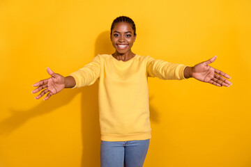 Portrait of attractive cheerful girl calling you come to me hugging isolated over bright yellow color background