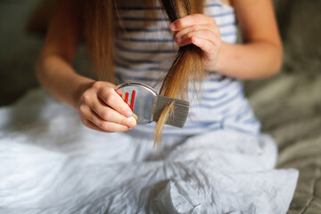 long-haired european girl child with lice comb, protection. health and pharmaceutical concept, child