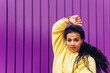 © Dani D.G - Young dancer raising her arms while dancing flamenco. Dance concept, young people, urban, real life, power, strength and purple background.