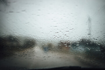 Canvas Print - Close up shot of rain dropping on the glass on a car