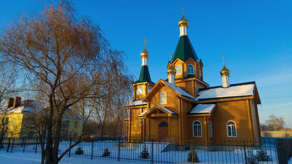 Canvas Print - Beautiful church with golden facade and snow on the roof in Russia