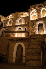 Wall Mural - Beautiful view of a stone village complex with night illumination, Tunisia