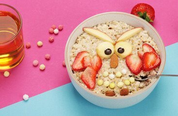 Poster - Creative oatmeal breakfast for kids on colourfull background.