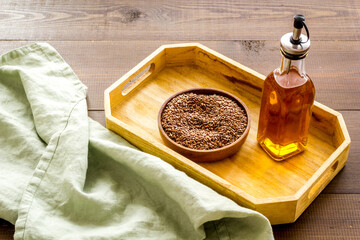 Wall Mural - Bottle of sesame cooking oil with seeds in bowl