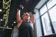 Low angle view of the midget woman lifting the dumbbells