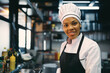 © Drazen - African American female chef working at restaurant and looking at camera.
