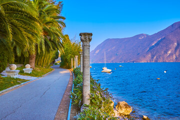 Canvas Print - The pleasant park Villa Heleneum on the shore of Lugano Lake with a view on the mountains on the other side, Lugano, Switzerland