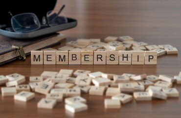 Wall Mural - membership word or concept represented by wooden letter tiles on a wooden table with glasses and a book