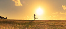 Man Running Across A Field At Sunset. Active Fit Healthy, Fitness Lifestyle Concept. 