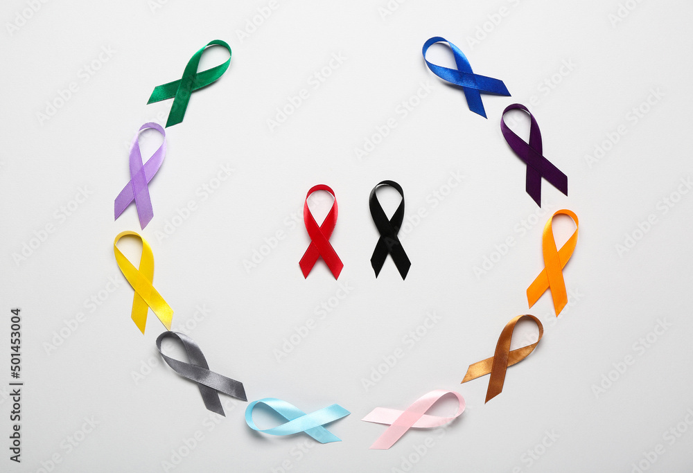Colorful awareness ribbons on light background. World Cancer Day concept