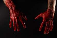 Male Bloody Hands On A Black Background. 