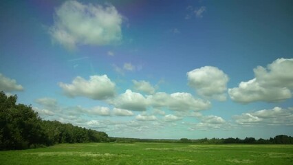 Wall Mural - blue sky background with white clouds in sunlight