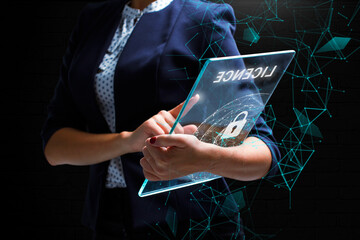 Business, Technology, Internet and network concept. Young businessman working on a virtual screen of the future and sees the inscription: Licence