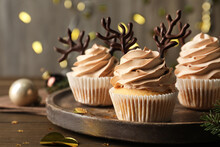 Tasty Christmas Cupcakes With Chocolate Reindeer Antlers On Wooden Tray, Closeup