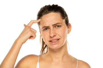 Wall Mural - Portrait of confused charming young woman touching forehead ask you to remember think isolated on white background