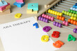Paper sheet with abbreviation ABA (Applied behavior analysis), abacus and colorful numbers on white wooden table