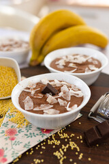 Sticker - Board with two bowls of chocolate mousses and banana near the board