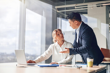 Wall Mural - confident business partners discussing plans and strategy in light modern office. High quality photo