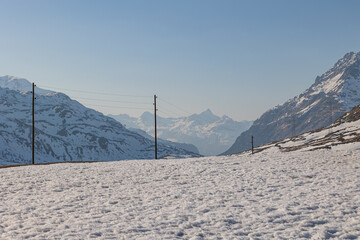 Wall Mural - Landscape of a mountain valley covered with snow and the road passing through them