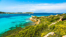 Beautiful View Of The Rocky Shore With Green Vegetation And Bluish Turquoise Sea. Sardinia, Italy.
