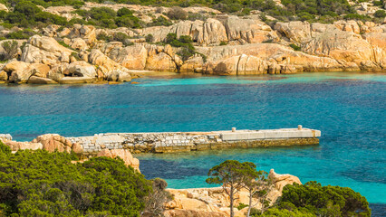 Sticker - Beautiful view of clear water surrounded by the rocky seashore on Sardinia island