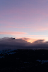 Sticker - Vertical photo of mist and mountains in Falera, a municipality in the Surselva Region, Switzerland