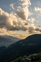 Sticker - Vertical photo of clouds and mountains in Falera, a municipality in the Surselva Region, Switzerland