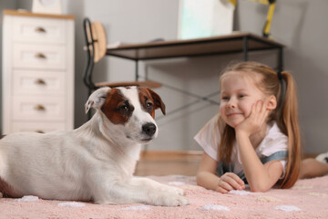 Canvas Print - Cute little girl with her dog on floor at home. Childhood pet