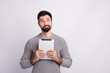 © Tetiana - Photo of young guy wondered look empty space use tablet idea smart isolated over grey color background