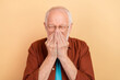 Photo of mature grandfather feel unwell sick cover face coughing suffering pain isolated on beige color background