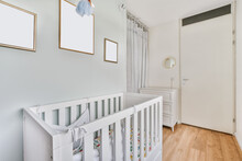 Interior Of Bedroom With Baby Crib In Daytime