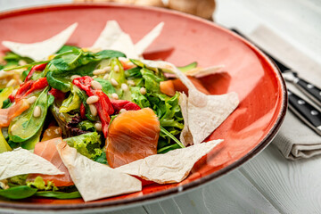 Wall Mural - Salmon salad with spinach, vegetables and pine nuts.