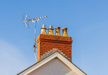 A Television Aerial On A Chimney Stack Against A Blue Sky.  Wales. UK

