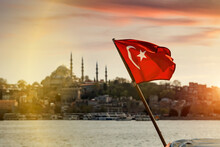 Turkish Flag Over Bosphorus Boats, Mosques, And Minarets Of Istanbul, Turkey.