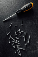 Wall Mural - Screwdriver and nails on wooden background