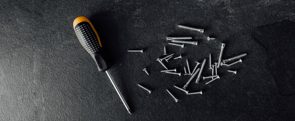 Wall Mural - Screwdriver and nails on wooden background