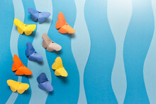 Paper Composition With Colorful Origami Butterflies On Blue Wavy Background