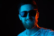 © stenkovlad - Man with sunglasses in neon light