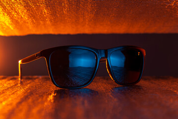 Sunglasses in orange light. fashion sunglasses