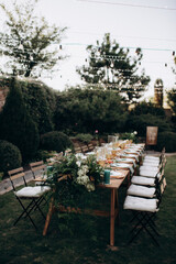 rectangular wedding festive set table in the patio, garden in nature