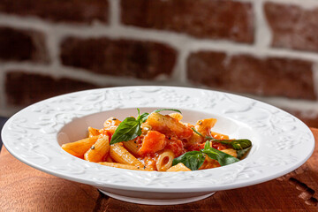 Wall Mural - Penne in tomato sauce with basil on top