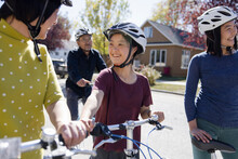 Happy Young Woman With Down Syndrome Riding Bikes With Family