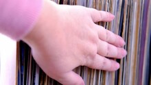Close-up Of Female Hands Choosing Vinyl Records Antiques Old Furniture Ta