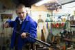 © JackF - Lubricating and cleaning the barrel of rifle in a gun workshop