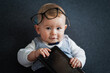 © shellygraphy - intelligent Cute baby genius who looks like a little student well dressed in vest and bow tie with glasses holding tablet for working and education on grey background