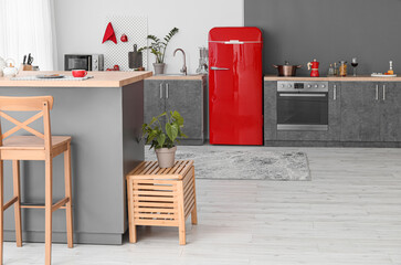 Canvas Print - Interior of modern kitchen with red fridge, counters and pegboard