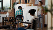 © DC Studio - African american woman with disability attending art class program to develop drawing skills for educational growth. Creative lesson in wheelchair to draw artistic vase design on canvas.